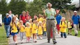 Ashley Bryan (center) walks with Islesford students