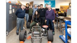 Members of the Formula SAE team and interim CTO Robert Reinckens (far left) met renowned  race car driver Simon Kirkby (far right).