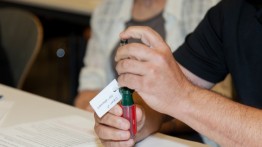 A judge examines the Second Place Winning Invention, the “Push-n-Twist Screwdriver”