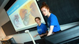 Jessica Marshall and Deanna Kovalcin demo their universal tape dispenser

