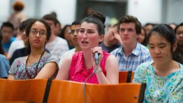 A young audience member asks a question of the panel

