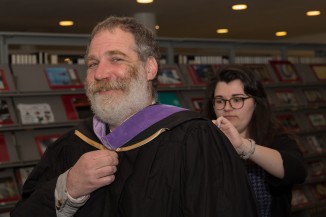 Ashley Armitage helped Professor David Gersten before the ceremony. 