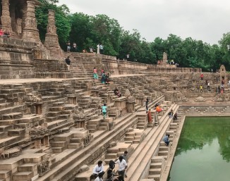 Flights of steps descend from the temple pavilion towards the water in the Suryakund, Mehsana.