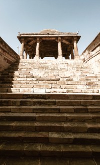 A domed, ground-level entrance pavilion leading to a subterranean stepped corridor in Jethabhai vaav, Ahmedabad. 