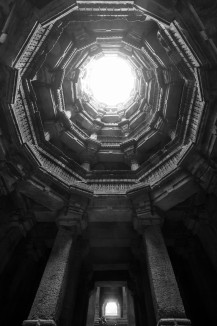 Looking up the octagonal ring of galleries from the deepest level of Bai Harir vaav in Asarwa, Ahmedabad. This stepwell displays exceptionally detailed stone ornamentation. 