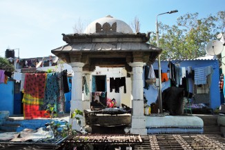 An old man in the neighborhood has chosen an unusual spot for his daily siesta—he mounts his wood frame bed precariously atop the spiral staircase shaft of the Ashapura maata vaav, where cool, subterranean air flows from the well. 